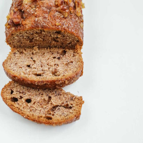 Freshly baked, sliced loaf of soft vegan banana bread.