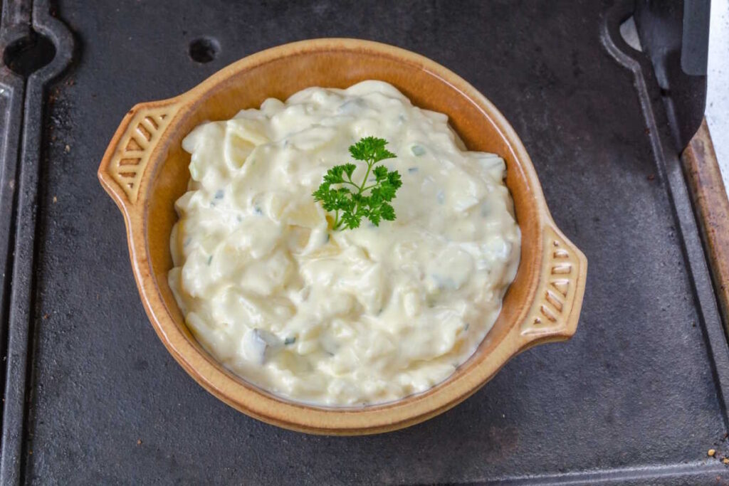 Creamy vegan potato salad with mayonnaise, pickle and diced celery.