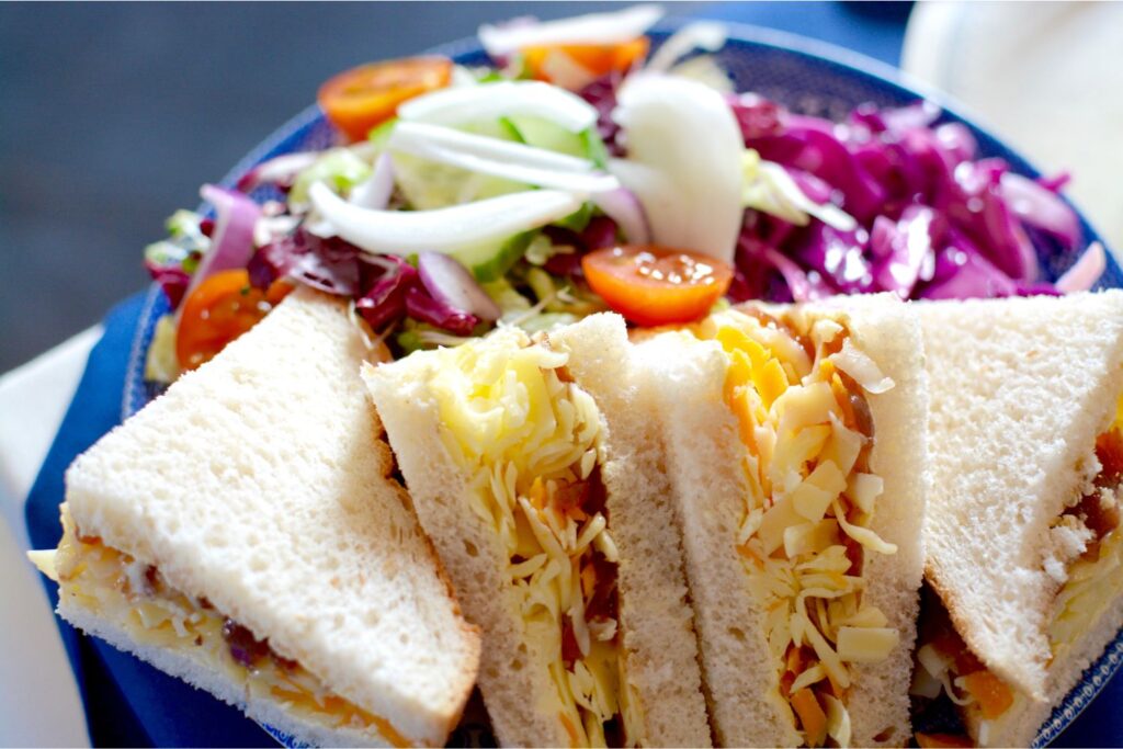 Plant-Based Cheese and Pickle served between Soft White Bread.