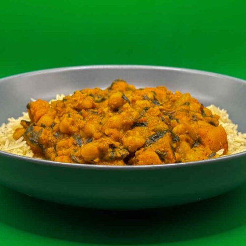 Chickpea spinach and sweet potato curry served on a bed of warm basmati rice.