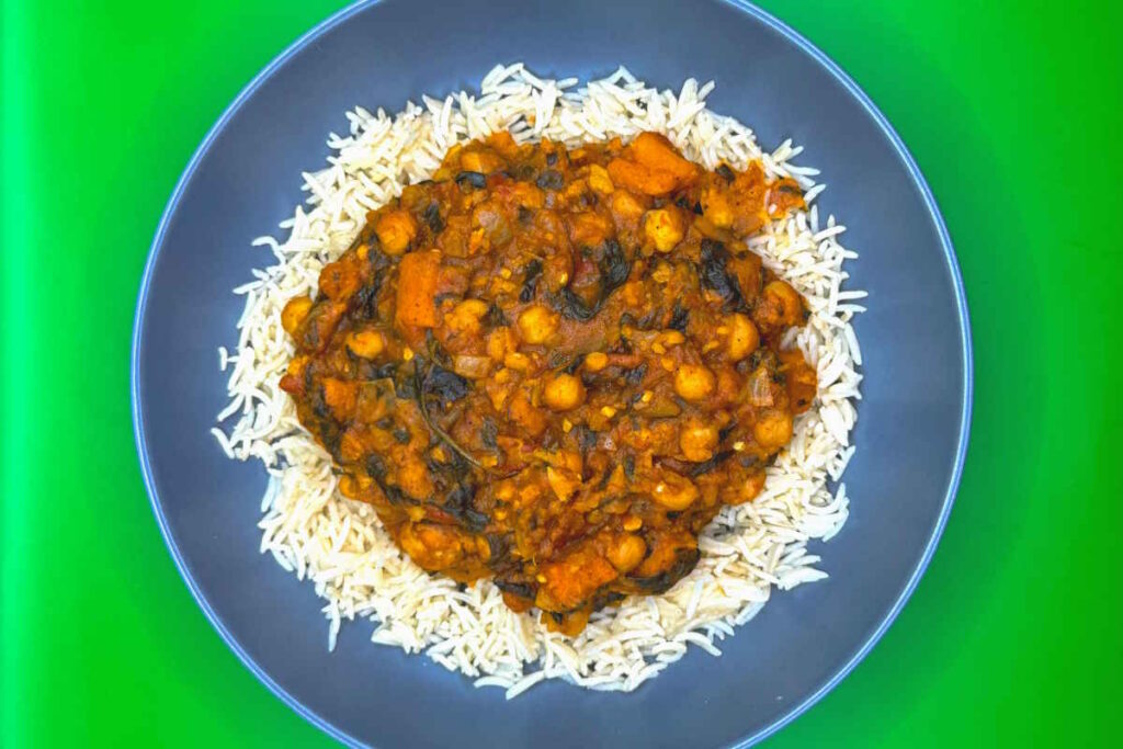 Chickpea spinach and sweet potato curry served on a bed of warm basmati rice.