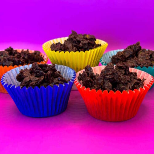 A bunch of colourful cupcake cups full of crispy chocolate and golden syrup covered cornflakes.