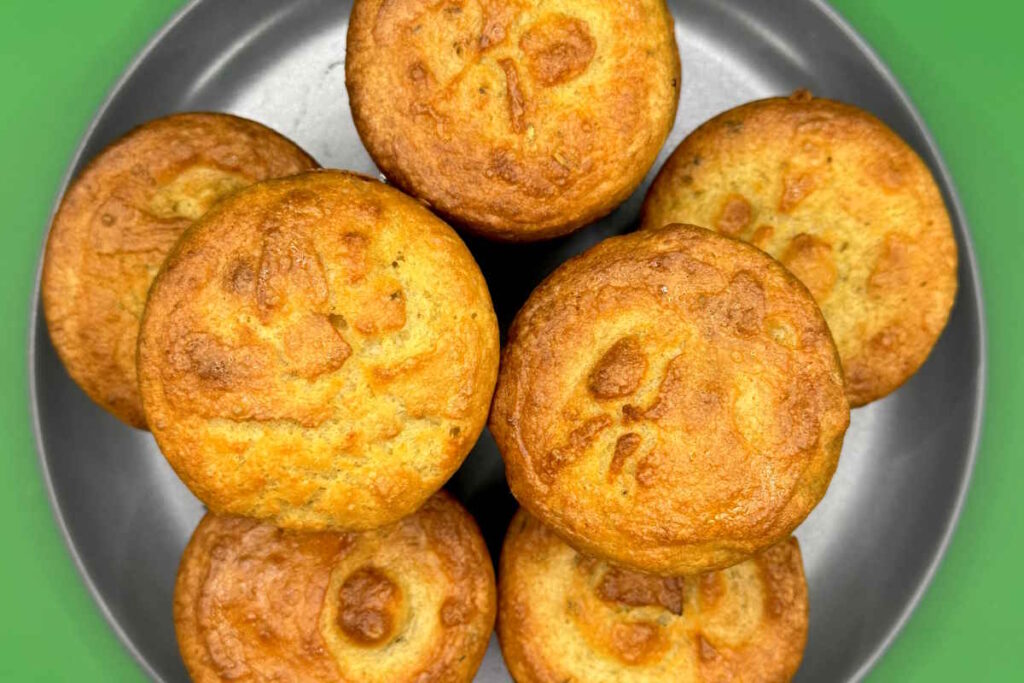 A plate of golden and crisp vegan Yorkshire puddings.