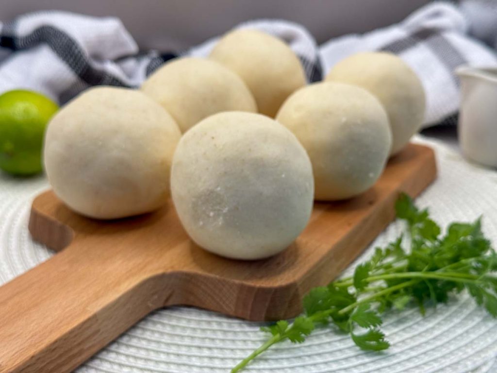 Dough balls formed from arepa dough by rolling them in your palms