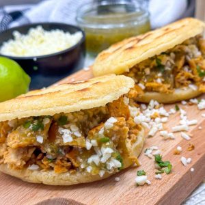 Vegan Arepas with Mexican Style Shredded Plant Chicken served with Salsa Verde, Lime Wedges and Vegan Cheese