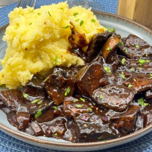Vegan beef tips and gravy served with mustard mashed potatoes.